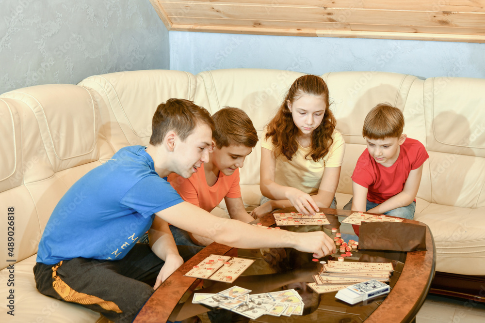 Four children are playing a lotto board game.