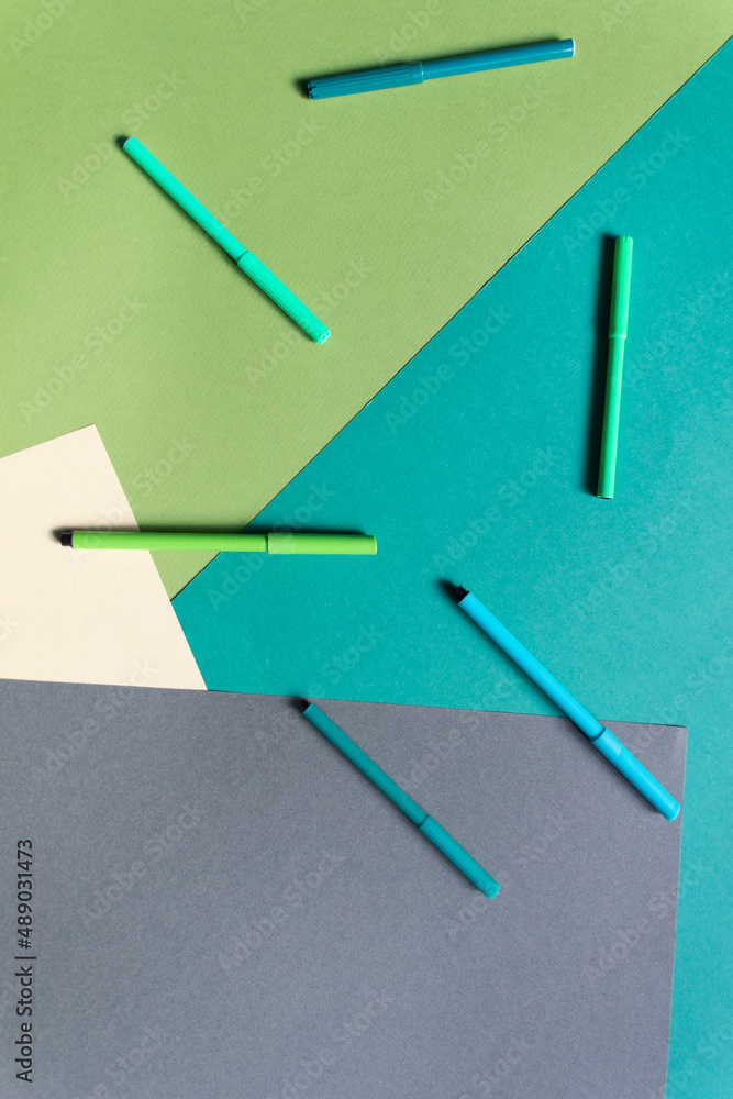 Markers on Paper background of different tints of green color Markers on Paper background of different tints of green color