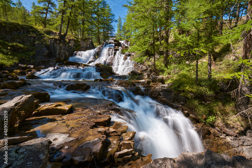 Fontcouverte Waterfall in the Claree Valley surrounded by larch trees in summer. Vall  e de la Clar  e in Hautes Alpes  Cerces Massif   Alps  France
