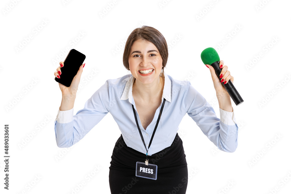 Happy young girl, female journalist holding reporter microphone isolated on white studio background. Concept of social media, press, news, information Happy young girl, female journalist holding reporter microphone isolated on white studio background. Concept of social media, press, news, information
