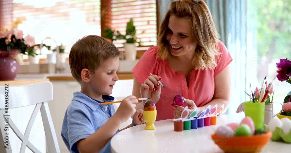 Happy family time while painting easter eggs together at home. Happy family time while painting easter eggs together at home.