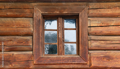 Window of an old wooden log house.