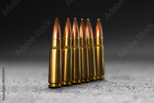 Bullets on gray background. Cartridges 7.62 caliber for Kalashnikov assault rifle. Selective focus