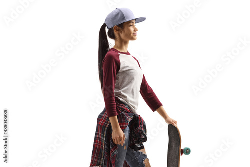 Trendy young female with a cap and a skateboard
