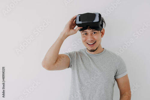 Happy Asian man present virtual glasses application for metaverse technology.