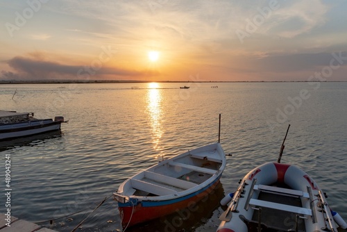 Beautiful background with boats in the lake at sunset