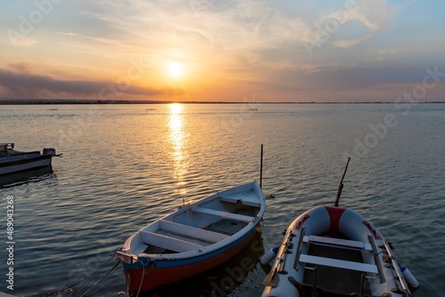 Beautiful background with boats in the lake at sunset © giadophoto