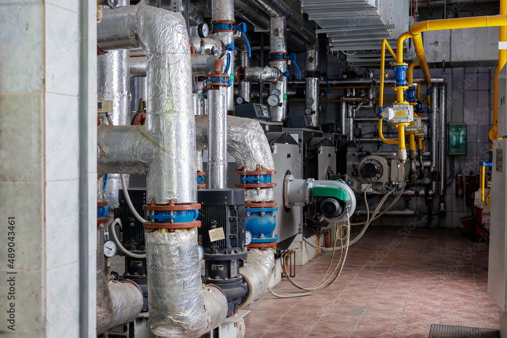 Closeup of manometer, pipes and faucet valves of heating system in a boiler room Closeup of manometer, pipes and faucet valves of heating system in a boiler room