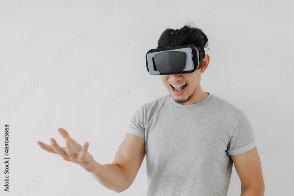 Asian man wears virtual glasses for interactive virtual meta world technology. Asian man wears virtual glasses for interactive virtual meta world technology.