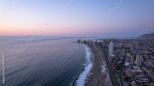 sunrise over the sea and the city of iquique photo