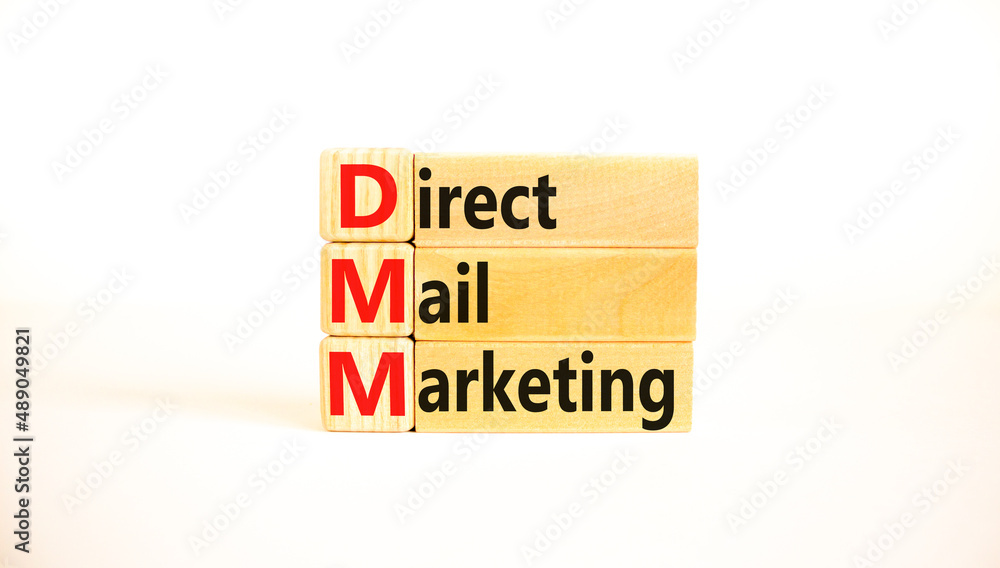 DMM direct mail marketing symbol. Concept words DMM direct mail marketing on wooden blocks on a beautiful white table, white background. Business and DMM direct mail marketing concept. Copy space. DMM direct mail marketing symbol. Concept words DMM direct mail marketing on wooden blocks on a beautiful white table, white background. Business and DMM direct mail marketing concept. Copy space.
