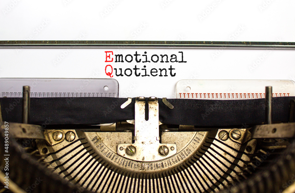 EQ emotional quotient symbol. Concept words EQ emotional quotient on white paper typed on retro typewriter. Beautiful white background. Business EQ emotional quotient concept, copy space.