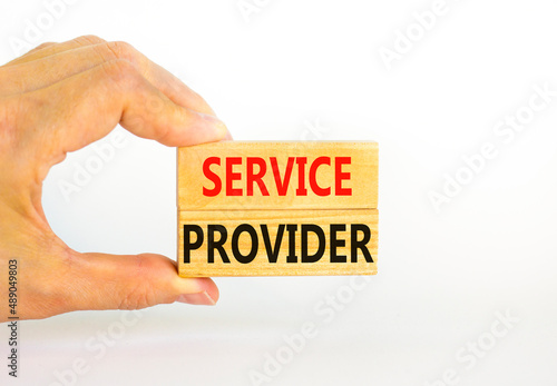 Service provider symbol. Concept words Service provider on wooden blocks on a beautiful white table white background. Businessman hand. Business services and service provider concept, copy space.