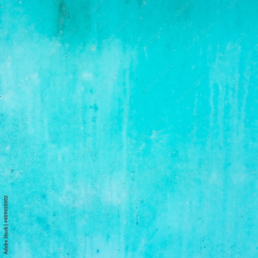 Textures of cyan painted grunge concrete background