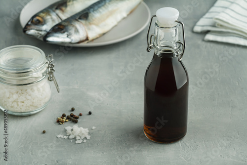prepared by fermentaion of fish salty sauce garum in a bottle on grey background