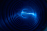 Futuristic tunnel. Blur neon background. Space technology. Defocused fluorescent blue color light ray in round ribbed vortex pipe on dark black.