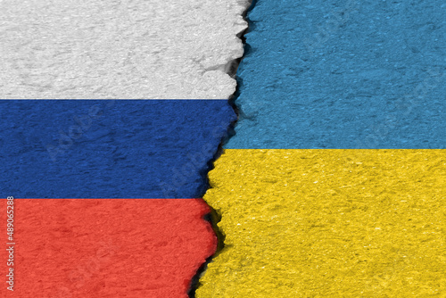 Russian and Ukrainian flags on a cracked concrete wall (conflict concept), background, texture