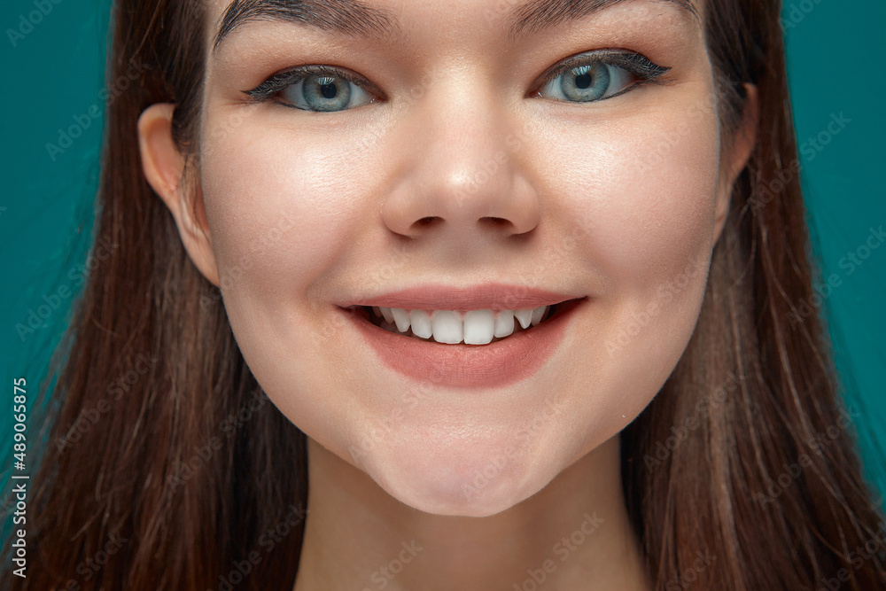 Close up young girl with healthy smile, white teeth, satisfied with dental whitening service. Natural beauty, hygiene Close up young girl with healthy smile, white teeth, satisfied with dental whitening service. Natural beauty, hygiene