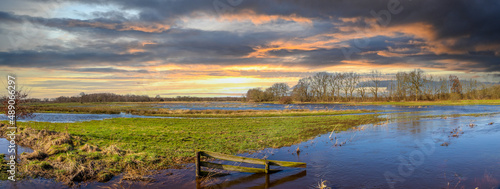 Sunset landscape of the catchment area of the Gastersche Diep, part of the Drentse Aa. After extreme rainfall, the stream bursts its banks and the marsh overflows along the banks photo