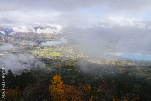 fog over the mountains and Serre Ponçon lake, alps, france on a fall day