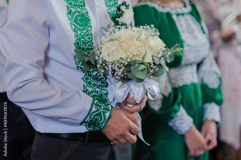 Wedding bouquet in the hands of the groom Wedding bouquet in the hands of the groom