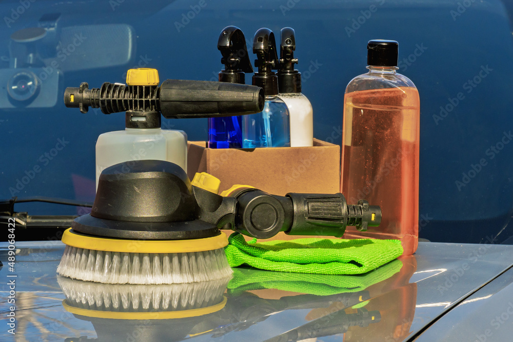 Car wash products are on the hood.
