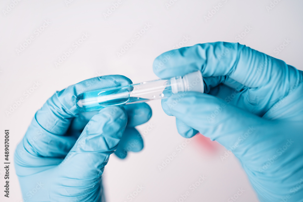 Doctor analyzing patient nasal swab sample for new covid-19 mutation. Doctor analyzing patient nasal swab sample for new covid-19 mutation.