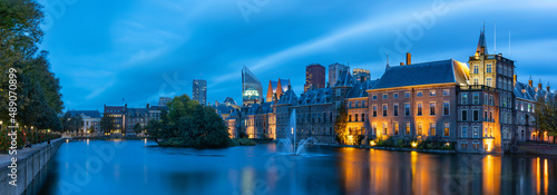 Panoramic photo during the blue hour on a windy autumn day of the Hofvijver and the Binnenhof with the parliament buildings in The Hague