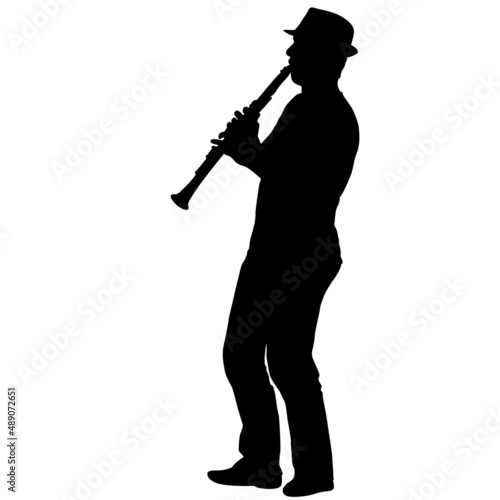 Silhouette of musician playing the clarinet on a white background