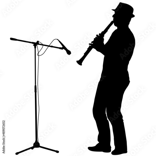 Silhouette of musician playing the clarinet on a white background