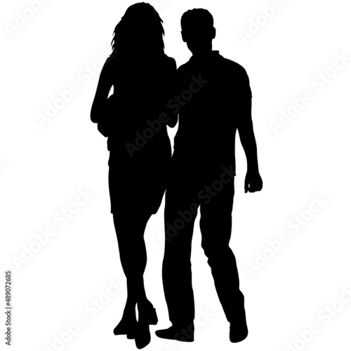 Silhouette man and woman walking hand in hand