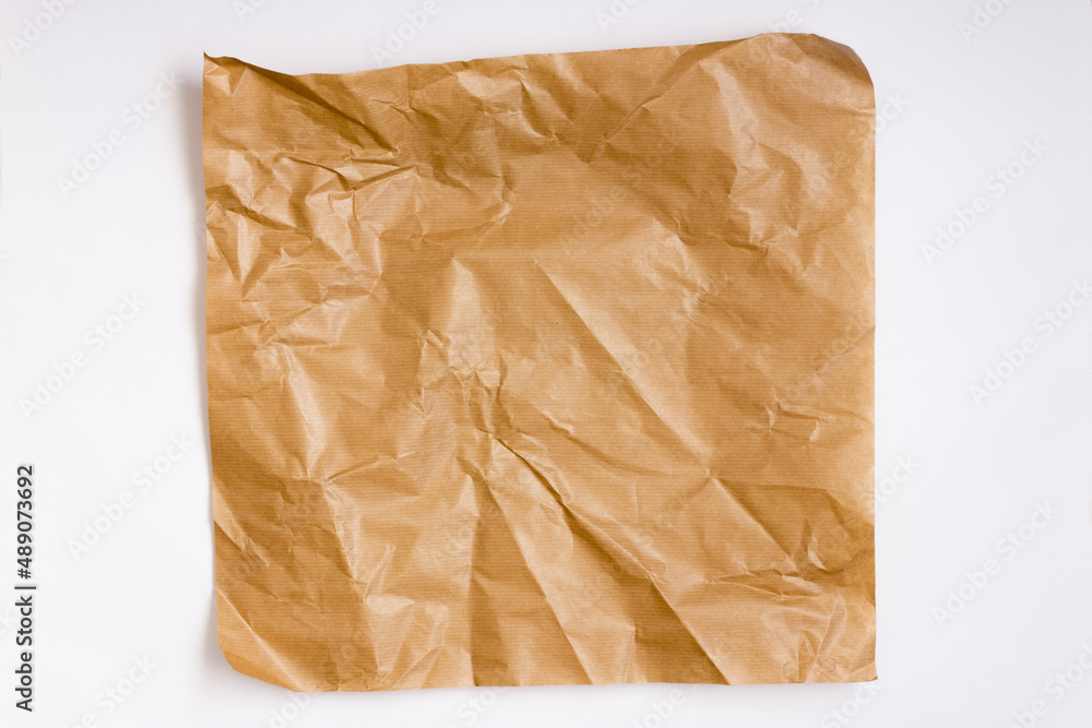 Sheet of crumpled light-brown laid paper. Copy space. Texture of paper for background. Sheet of crumpled light-brown laid paper. Copy space. Texture of paper for background.