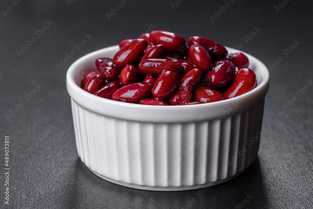 Canned red kidney beans in white bowl on a table Canned red kidney beans in white bowl on a table