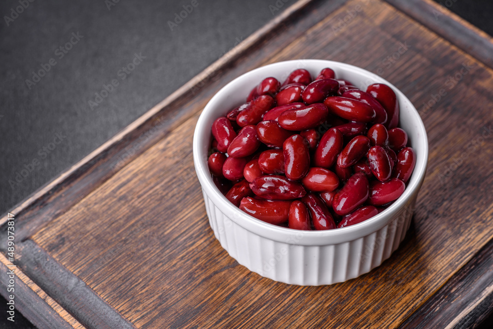 Canned red kidney beans in white bowl on a table Canned red kidney beans in white bowl on a table