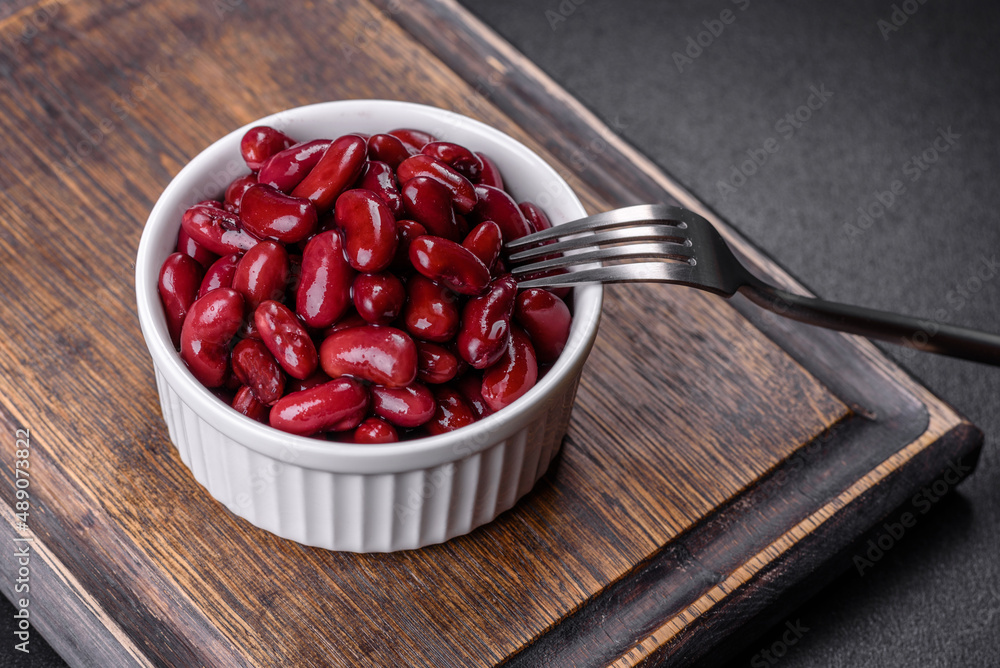 Canned red kidney beans in white bowl on a table Canned red kidney beans in white bowl on a table