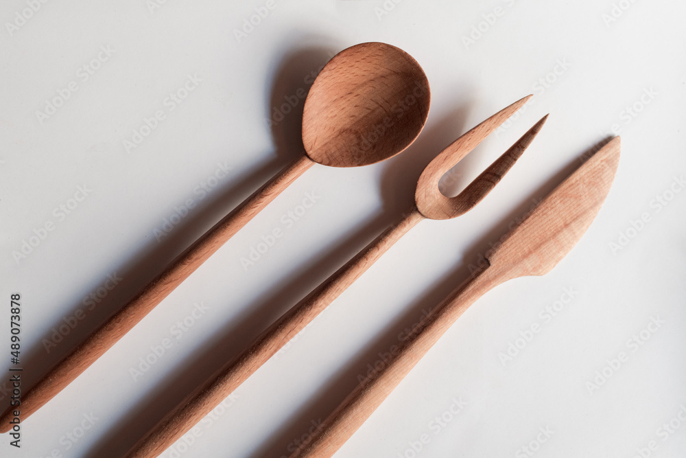 Handmade Wooden Spoons for hiking and outdoor activities. Craftsmanship and artisan concept Handmade Wooden Spoons for hiking and outdoor activities. Craftsmanship and artisan concept
