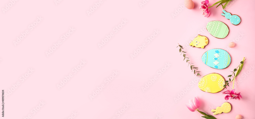 Beautiful composition with tasty Easter cookies on pink background with space for text