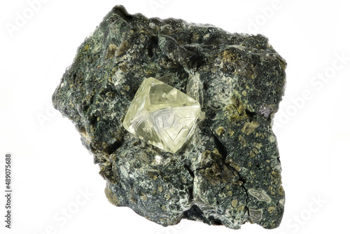 0.55 ct octahedral diamond from South Africa nestled in kimberlite isolated on white background photo