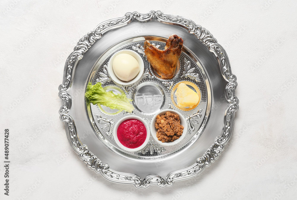 Passover Seder plate with traditional food on white background Passover Seder plate with traditional food on white background