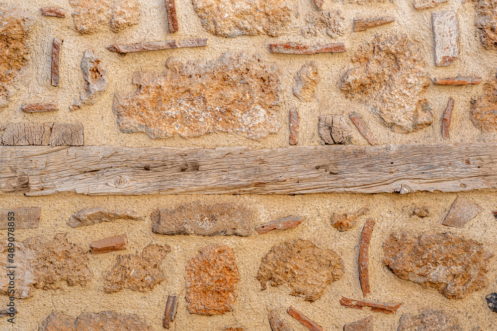 background, texture - rough masonry from wild stone and cement on a wooden frame