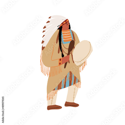 Native American shaman beats the drum. Wild West Indian American man performing tribal ritual dance of indigenous people