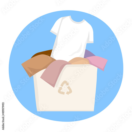 Container with old clothes and a white t-shirt for recycling and donations