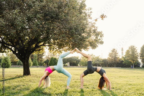 2 girl doing outdoor sport training and yoga in the park.