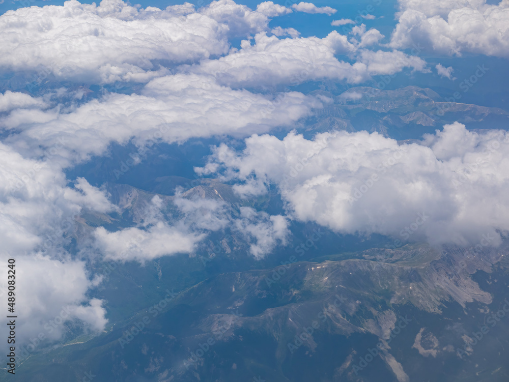 Aerial view of mountain landscape, view from window seat in an airplane