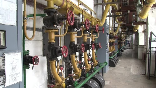 Boiler room with pipes, valves and sensors.Manometer, pipes and faucet valves of heating system in a boiler room.