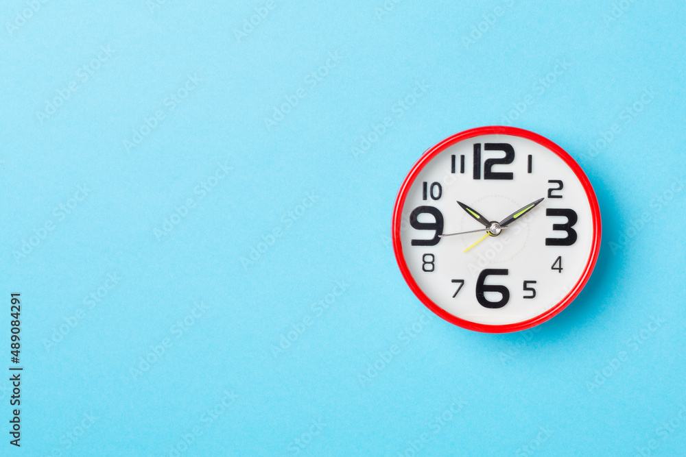 Red alarm clock on color background, top view Red alarm clock on color background, top view
