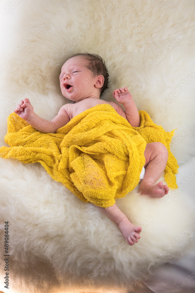 cute small newborn baby sleeping on a sheep fur. High quality photo cute small newborn baby sleeping on a sheep fur. High quality photo