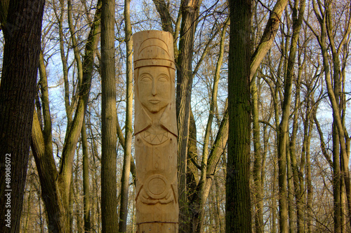 The temple of a pagan idol in the park. Statues made of wood, a temple in the forest