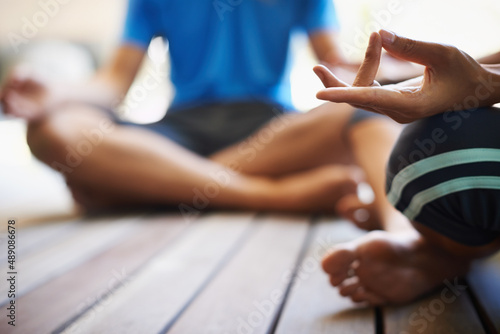 Perfect poise found through yoga. Cropped view of a two people doing yoga in the lotus position. photo