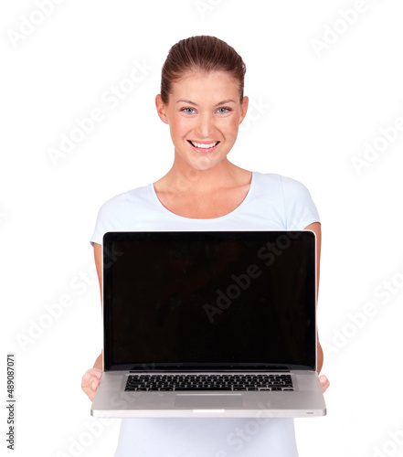 Whats this Its a view to the world. A lovely young woman presenting a top of the line laptop to you - isolated.